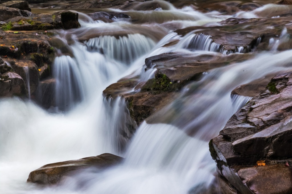 Beautiful DSLR photography example of water flowing on rocks.